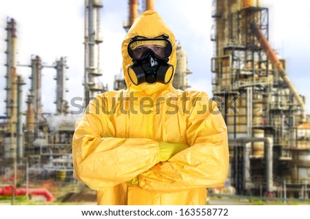 Man in chemical protective suit over factory