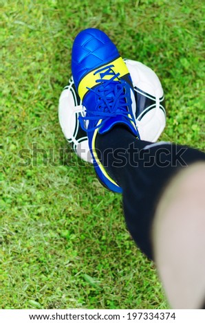Beginning of the match. Footballer with the ball. Top view.