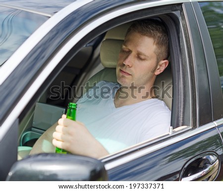 Driving Under the Influence. Man drinking alcohol in the car.