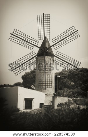 Portrait of classic old tower windmill. Old photo effect.