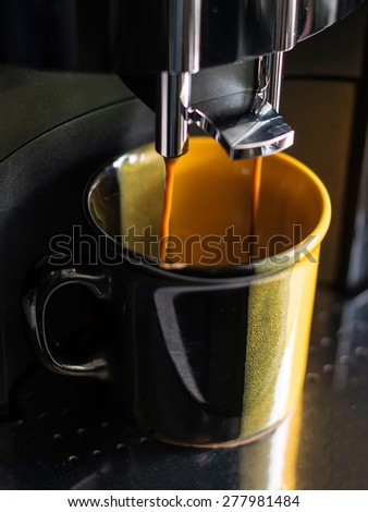 Professional coffee machine making coffee.