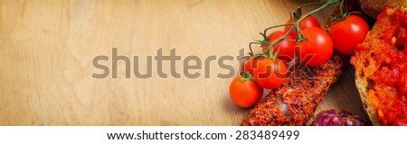 Bruschetta with tomato paste, tomatoes and fuet. Place for text.