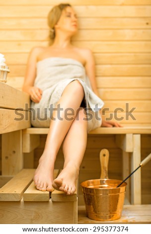 Young pretty woman relaxing in sauna.