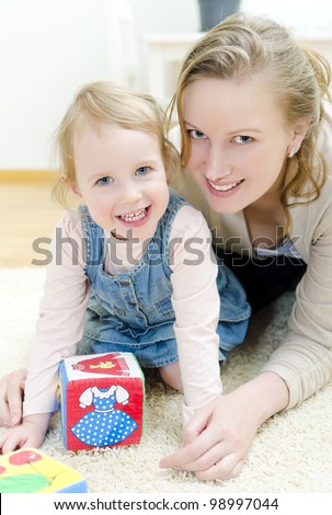 Mother and daughter playing in the children\'s cubes