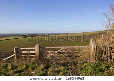 wooden farm gates overlooking cleaving coomb and the vale of york from the heights of the yorkshire wolds