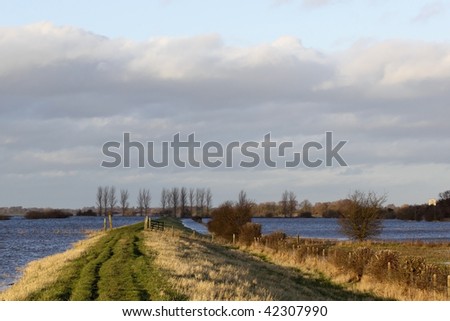 a view along the defensive banks of the river derwent in yorkshire during the winter floods