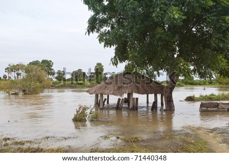 sri lankan landscape with a police army checkpoint submerged by flood waters