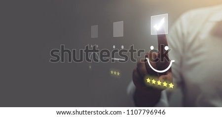 Businessman pressing smiley face emoticon on virtual touch screen. Customer service evaluation concept. Stockfoto © 