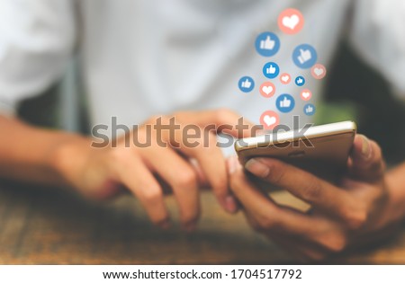 Young man using smart phone,Social Distancing ,Working From Home concept. 
