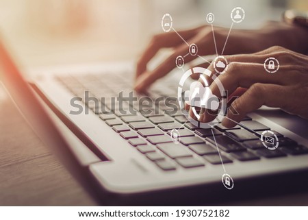 Young businesswoman working on his laptop in the office, select the icon cloud on the virtual display.Concept digital technology and cloud technolog 