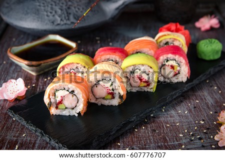 Similar – Image, Stock Photo Hot rolls with eel, Japanese omelette, cream cheese, fried onions and unagi sauce, decorated with fresh herbs. Japanese food on a bamboo platter, bamboo sticks, sauce on a light background. Copy space