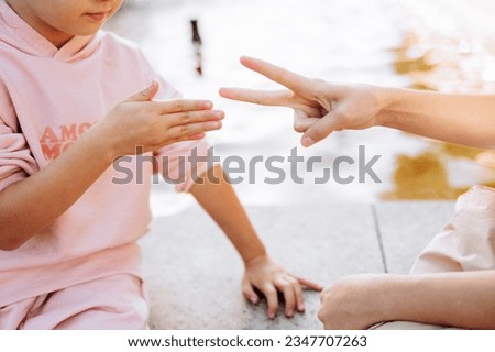 Similar – Image, Stock Photo Child playing with rocks and sand