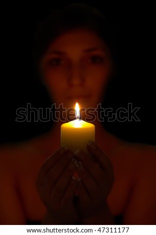 sensual woman portrait holding burning candle in her hands