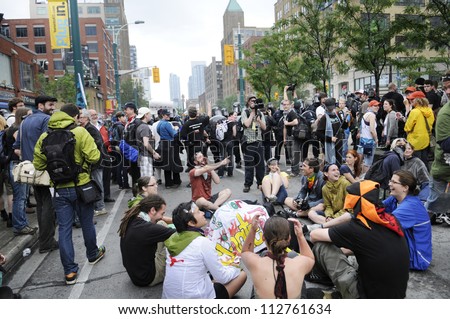 TORONTO-JUNE 26: Protesters sitting on the streets as a mark of protest after being not allowed to enter the perimeter of the event during the G20 Protest on June 26 2010 in Toronto, Canada.