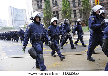 TORONTO-JUNE 26:   Elite riot police group marching on the streets during the G20 Protest on June 26, 2010 in Toronto, Canada.