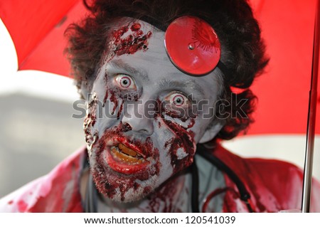 TORONTO-OCTOBER 20: A man with  fake blood stained face during the Halloween parade on October 20, 2012 in Toronto, Canada.