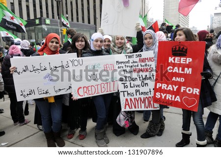 TORONTO-MARCH 16: Unidentified Syrian girls holding banners during a protest rally organized to raise awareness and commemorate two years of Syrian revolution on March 16, 2013 in Toronto, Canada.