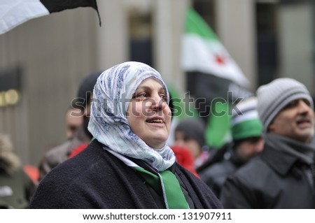 TORONTO-MARCH 16: An unidentified middle-aged Syrian woman chanting slogans during a protest rally organized to raise awareness and commemorate two years of Syrian revolution on March 16, 2013 in Toronto, Canada.
