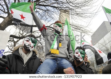 TORONTO-MARCH 16: Young unidentified Syrians chanting slogans during a protest rally organized to raise awareness and commemorate two years of Syrian revolution on March 16, 2013 in Toronto, Canada.
