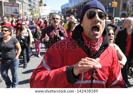 TORONTO-MAY 25: An angry protestor shouting slogans during a rally  against GMO giant Monsanto on May 25, 2013 in Toronto, Canada.