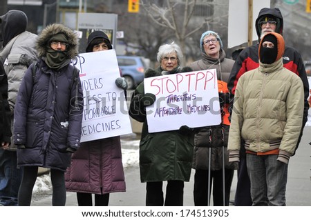 TORONTO-JANUARY 31:  A group of people holding banners and signs during a rally to protest the proposed TPP  trade agreement and NAFTA  Agreement on January 31, 2014 in Toronto, Canada.