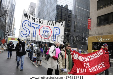 TORONTO-JANUARY 31: Protesters marching in  a rally to protest the proposed TPP  trade agreement and NAFTA  Agreement on January 31, 2014 in Toronto, Canada.