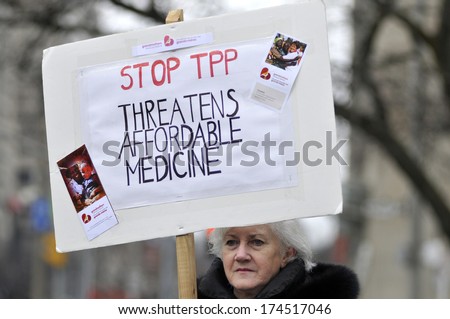 TORONTO-JANUARY 31:  An old woman with a sign to denounce TPP agreement during a rally  to protest the proposed TPP trade agreement and NAFTA  Agreement on January 31, 2014 in Toronto, Canada.