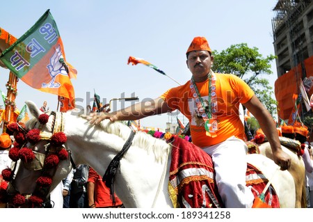 VARANASI-APRIL 24:  A supporter on horse back during a political rally to support Mr. Narendra Modi on April  24, 2014 in Varanasi , India.