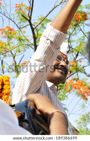 AMETHI - APRIL 20:  Arvind Kejriwal waiving towards the AAP supporters during a road show in support of Amethi candidate Dr. Kumar Viswas on April 20, 2014 in Amethi ,India.