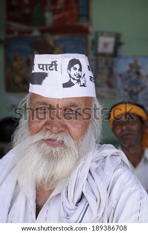 AMETHI - APRIL 21:  A tea stall vendor wearing AAP caps  during a road show in support of Amethi candidate Dr. Kumar Viswas on April 21, 2014 in Amethi ,India.