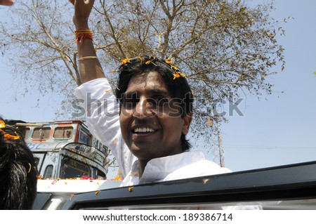 AMETHI - APRIL 21:  Dr. Kumar Viswas  being showered by flower petals during a road show on April 21, 2014 in Amethi ,India.