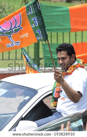 NEW DELHI-MAY 17:   A BJP supporter waiving a BJP flag  during a rally after wining the Indian National election on May 17, 2014 in New Delhi , India.
