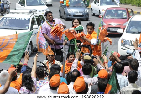 NEW DELHI-MAY 17:  BJP supporters distributing NAMO caps  to the waiting supporters during a rally after wining the Indian National election on May 17, 2014 in New Delhi , India.