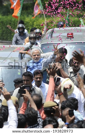 NEW DELHI-MAY 17: Indian Prime Minister Narendra Modi waiving towards the crowd while being showered by rose petals after wining the Indian National election on May 17, 2014 in New Delhi , India.