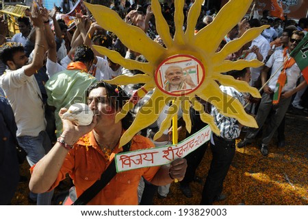 NEW DELHI-MAY 16:  A BJP supporter blowing  Shankha or a conch shell  as a form of sacred Hindu ritual after BJP won the Indian National election on May 16, 2014 in New Delhi , India.