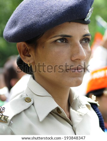 NEW DELHI-MAY 17:   A woman Delhi police constable keeping a close eye on the BJP supporters during a rally after wining the Indian National election on May 17, 2014 in New Delhi , India.