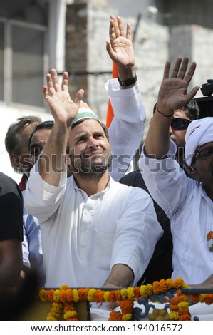 VARANASI - MAY 10: Rahul Gandhi waiving towards the people standing on top of buildings during a road show  to support local Congress candidate Mr. Ajay Rai on May 10, 2014 in Varanasi , India.