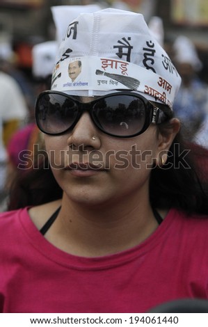VARANASI - MAY  8:  An Indian woman with AAP cap on a motorbike  during a  AAP motorbike rally  on May  8, 2014 in Varanasi , India.