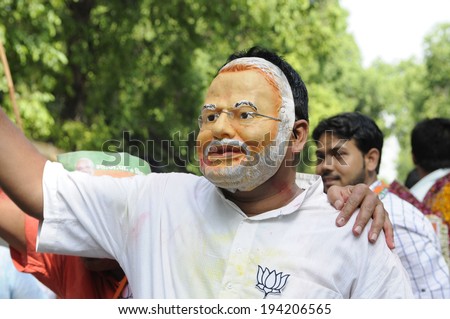 NEW DELHI-MAY 16: A BJP follower wearing a Modi mask as a form of celebration  after BJP won the Indian National election on May 16, 2014 in New Delhi , India.