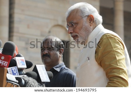 NEW DELHI-MAY 20:  Prime Minister Narendra Modi being guarded by his body guards  at Rashtrapati Bhavan during a press conference on May 20, 2014 in New Delhi , India.
