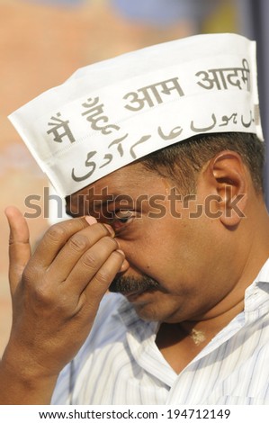 VARANASI - APRIL  27:  AAP leader  Arvind Kejriwal  cleaning up his eyes during an election rally on April 27, 2014 in Varanasi , India.