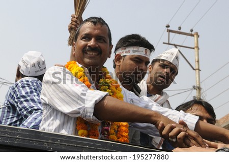 VARANASI - MAY  4 : Arvind kejriwal  shaking hands with his supporter during a political meeting on May 4 , 2014 in Varanasi , India.