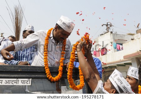 VARANASI - MAY  4 : Arvind kejriwal  being garlanded while he is on the top of the jeep during a political meeting on May 4 , 2014 in Varanasi , India.
