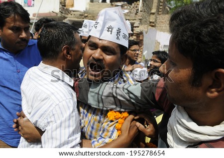 VARANASI - MAY  4 : Arvind kejriwal  being hugged by his supporter during a political meeting on May 4 , 2014 in Varanasi , India.