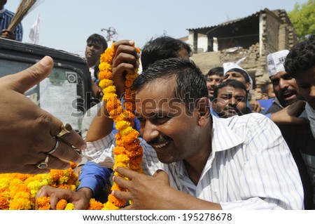 VARANASI - MAY  4 : Arvind kejriwal  being garlanded during a political meeting on May 4 , 2014 in Varanasi , India.