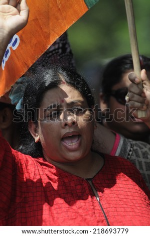 KOLKATA- SEPTEMBER 18: A woman activist shouting slogans during a student protest rally organized by Jadavpur university students against police atrocities on September 18, 2014 in Kolkata, India.