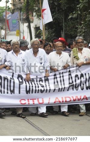 KOLKATA- SEPTEMBER 15:Old aged left Front leaders walking in a protest rally organized to demand the arrest of the persons involved in Saradha Chit fund scandal  on September 15,2014 in Kolkata,India.