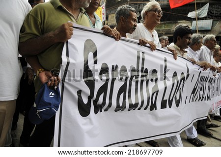 KOLKATA- SEPTEMBER 15: Protesters carrying banners during a protest rally organized to demand the arrest of the persons involved in Saradha Chit fund scandal  on September 15, 2014 in Kolkata, India.