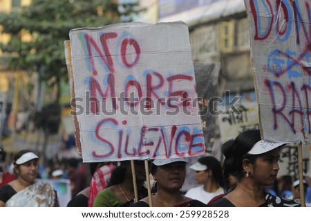KOLKATA -DECEMBER 16 : People with sign asking to report rape than hiding it  during a rally to remember the gang raped victim from New Delhi in the year 2012 -on December 16, 2014 in Kolkata ,India.