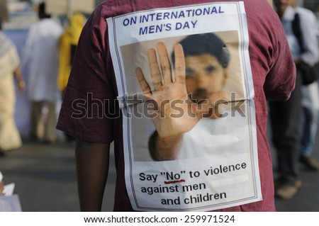 KOLKATA - NOVEMBER 15 :A man wearing a sticker denouncing violence against men and children during a rally to celebrate the International Men\'s Day on November 15, 2014 in Kolkata, India.